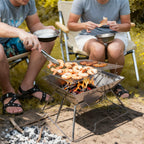 Campers grilling shrimp skewers over a portable folding steel fire pit and camping grill